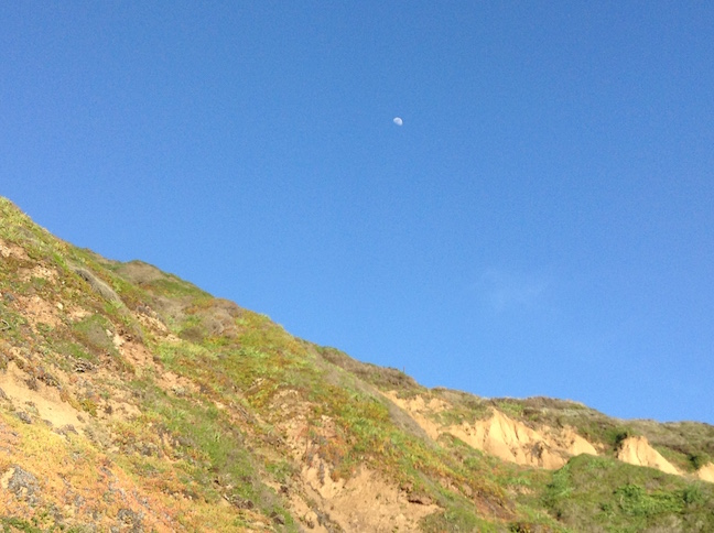 moon over beach cliffs