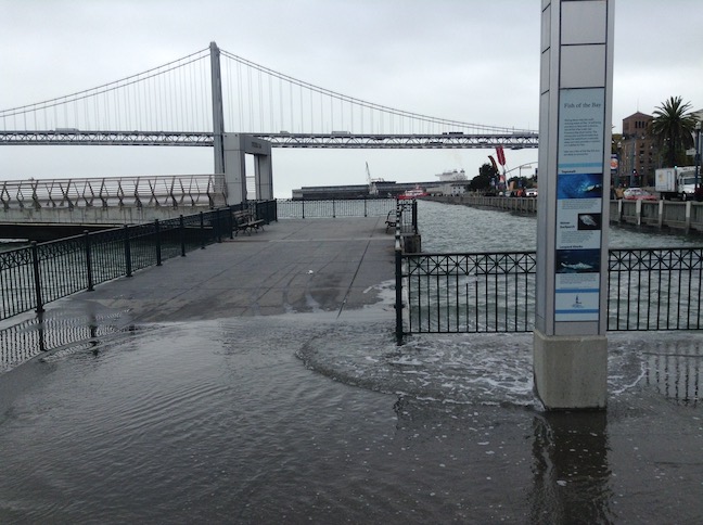king tide at pier 14, arrow sculpture in background
