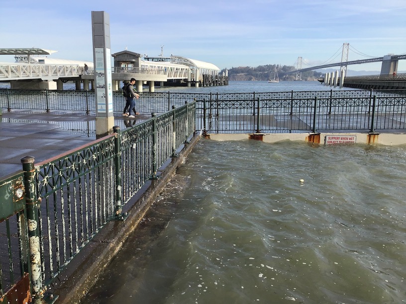 king tide at pier 14, looking east, with couple